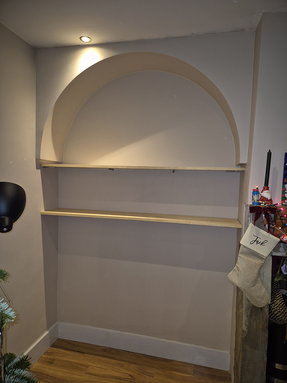 Finished installation featuring an arch with two built-in shelves