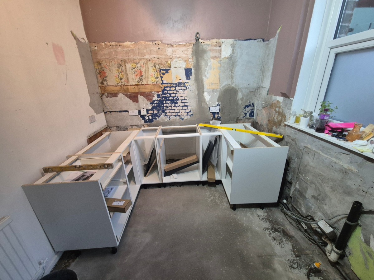 After self levelling cement was used, im now levelling up the kitchen cabinets