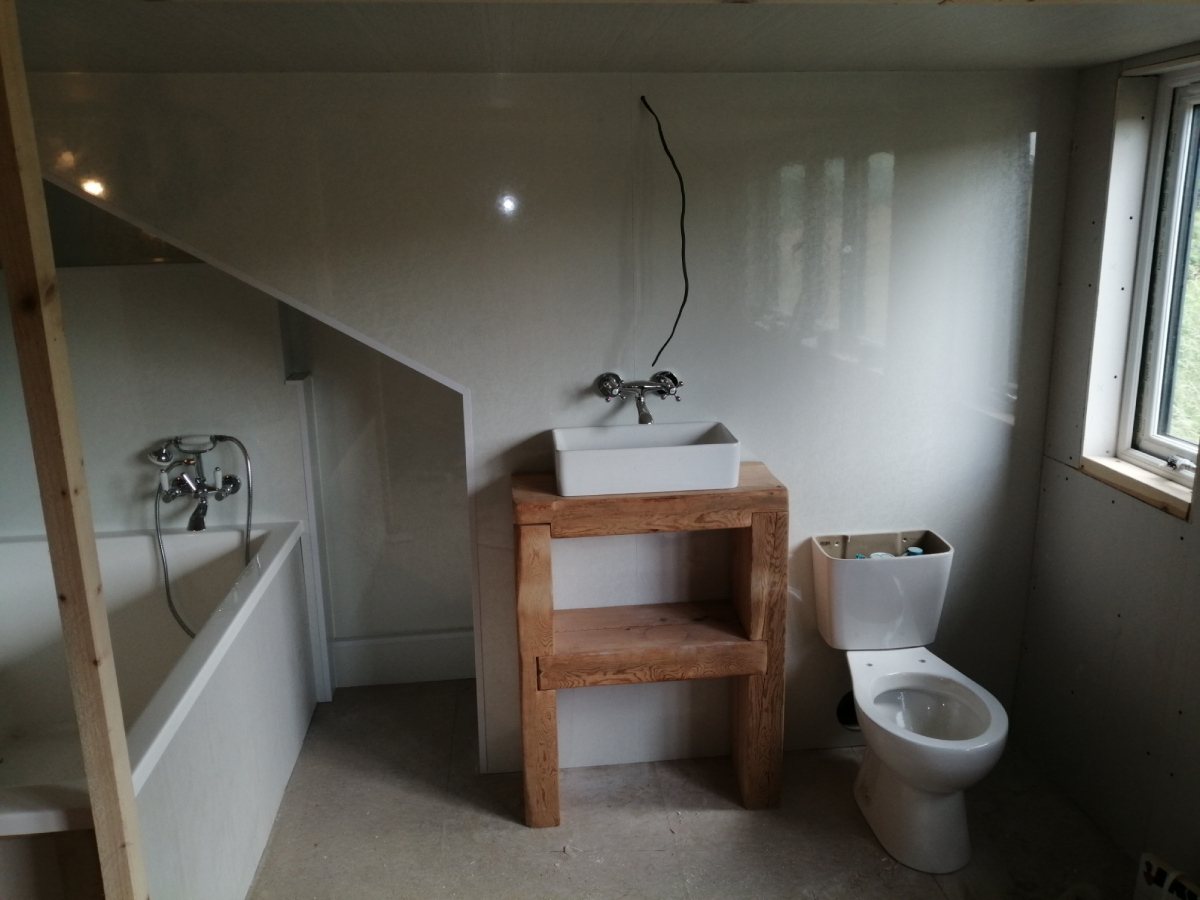 Bathroom fully built, just needs stud wall with glass block window