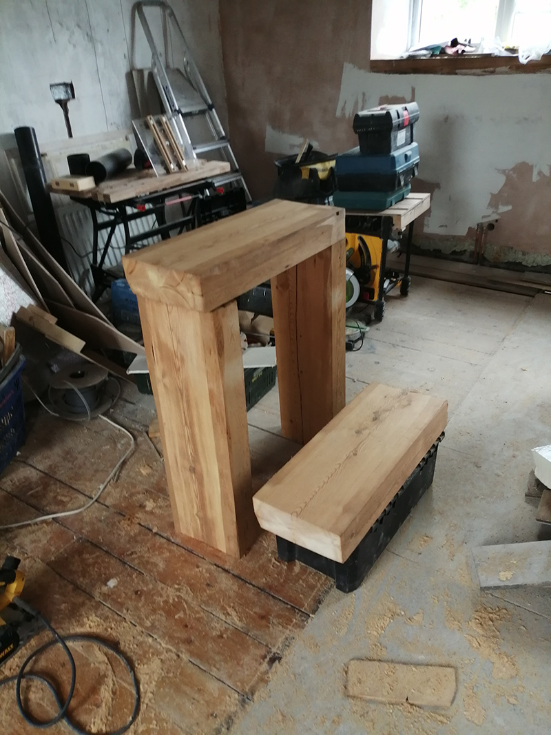 Reclaimed roof purlin being crafted into a sink stand