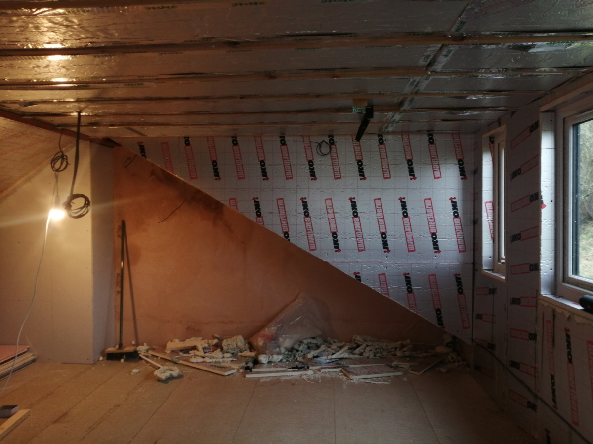 Empty room before bathroom installation, just after insulation was installed in the new dormer