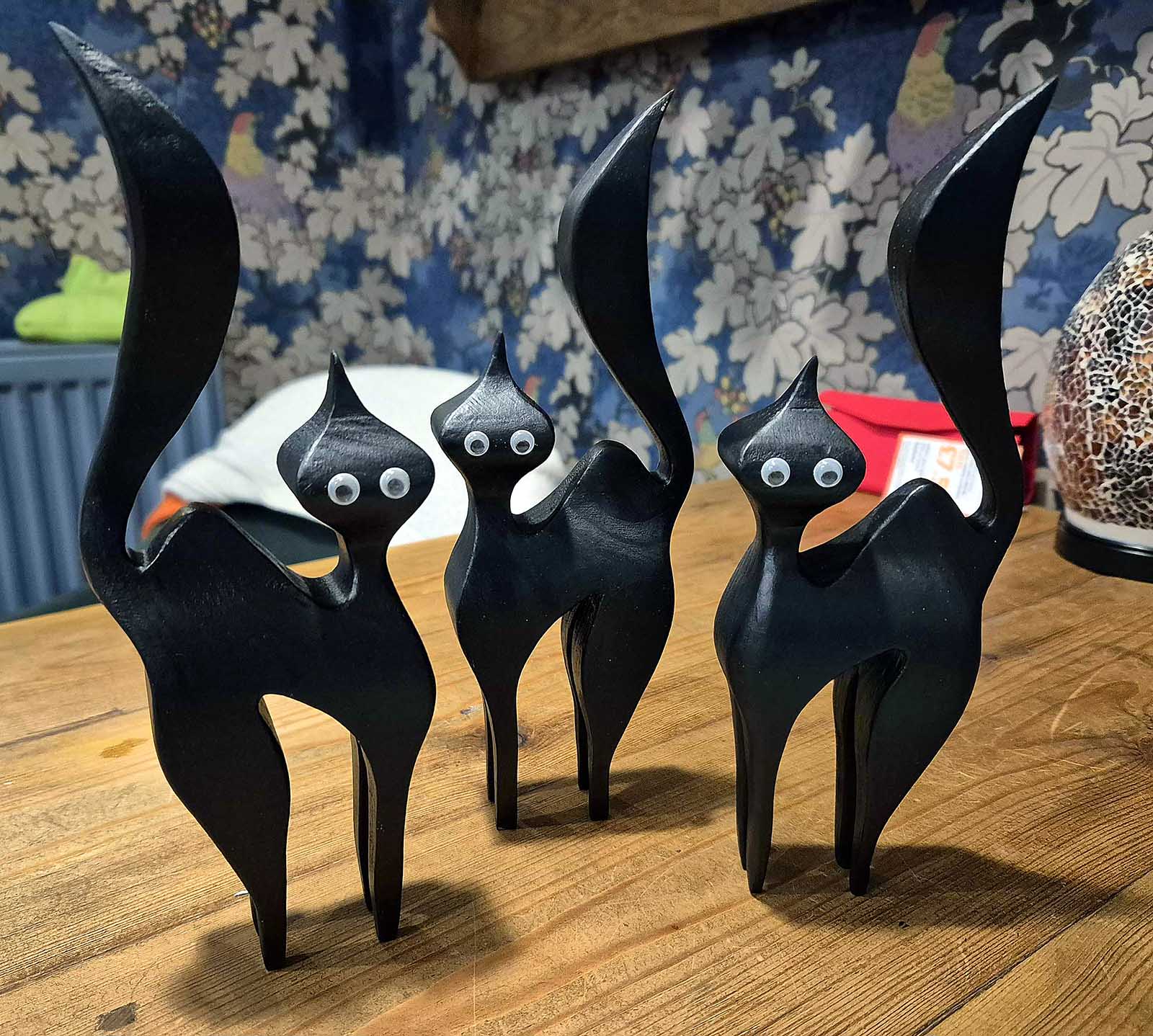 Three wooden witches cats